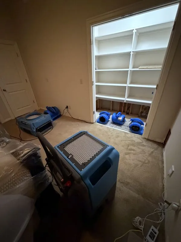 Flood cut and air movers drying a bedroom wall