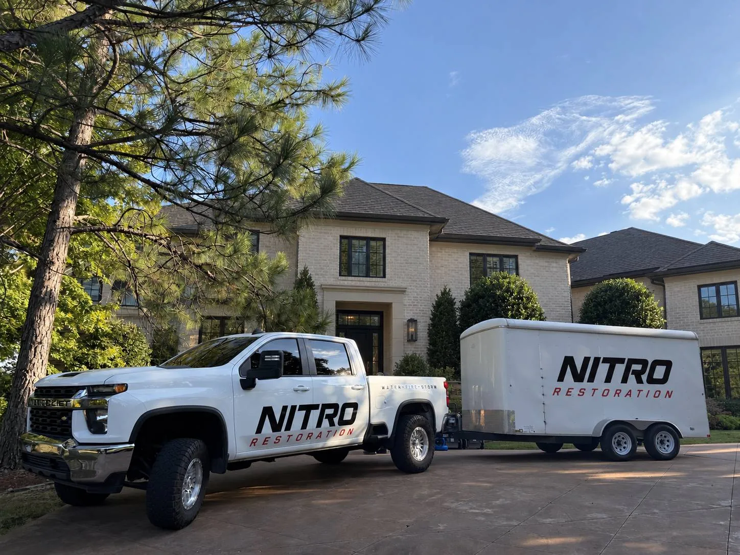 Nitro Restoration truck and equipment trailer on a Tulsa-metro job